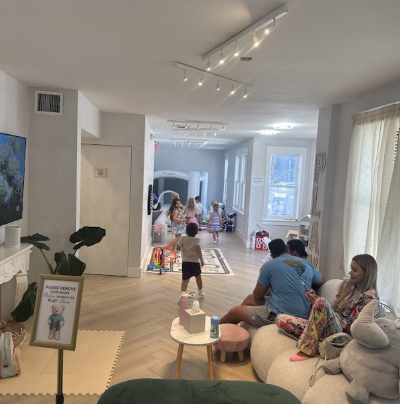 Wide view of the indoor Play Area with seating and open floor space