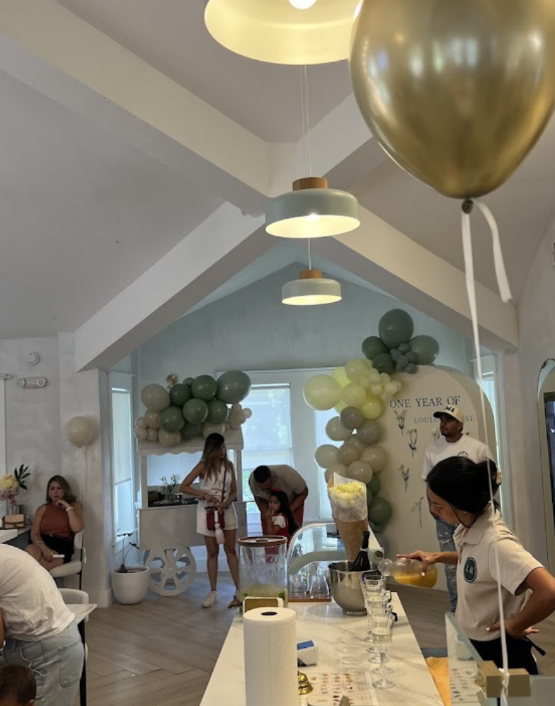 Private celebration set up with balloon arch and welcome bar