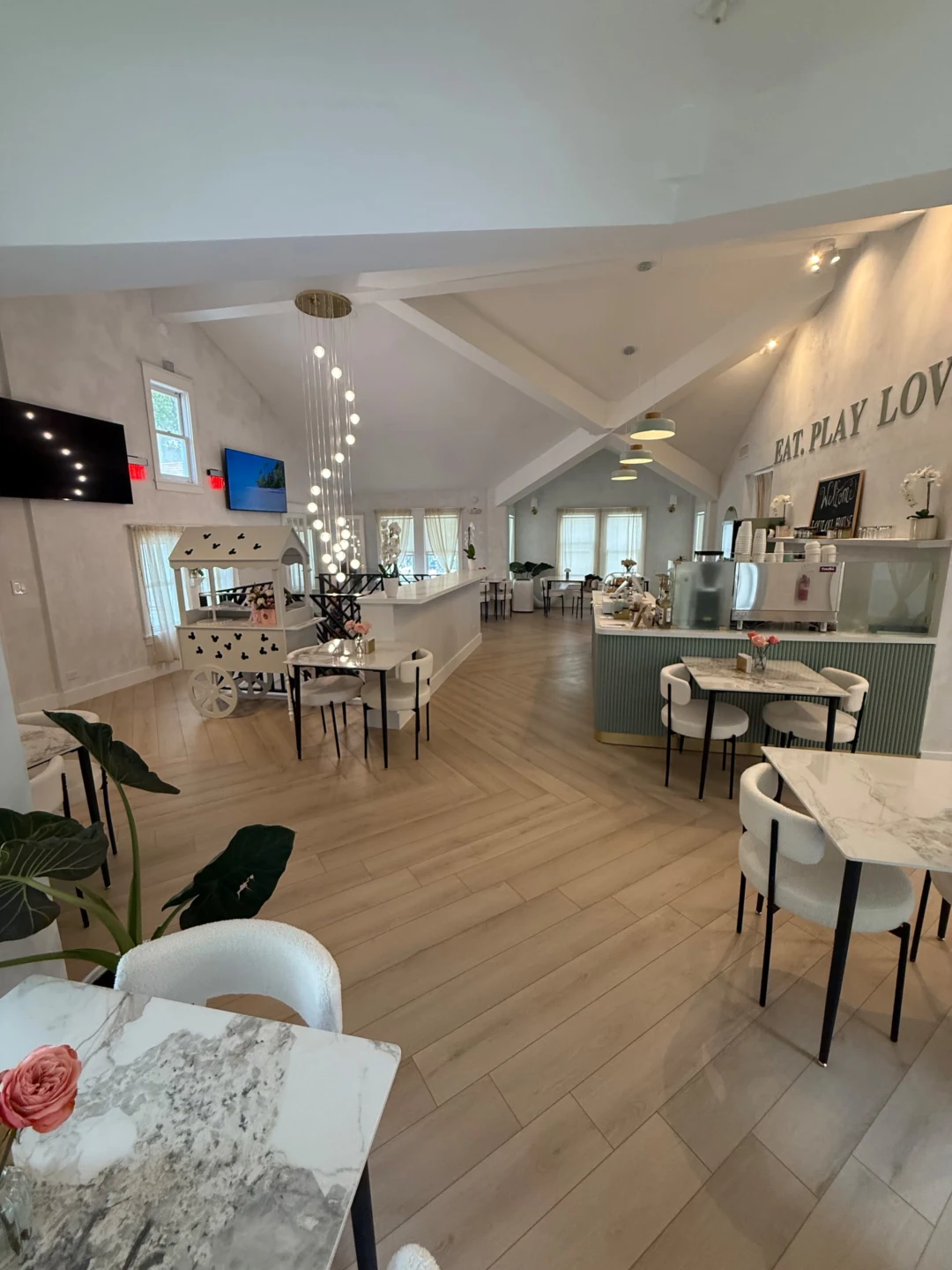 Wide interior view of the cafe with vaulted ceilings and herringbone floors