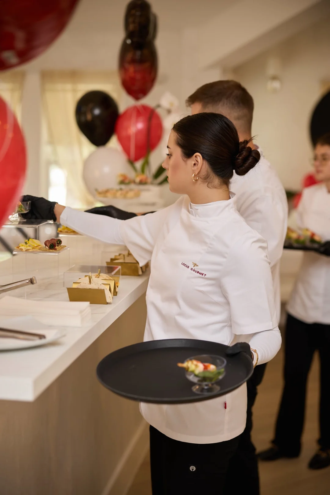 Catering team plating hors d'oeuvres at a private LOULOU HOUSE event