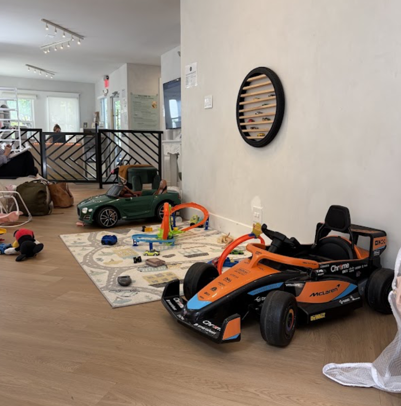 Ride-on car area with a racing toy car and track pieces