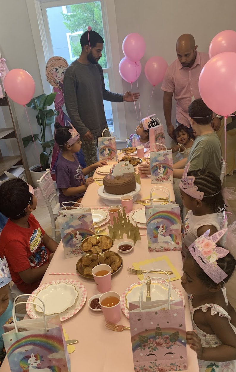 Children gathered around a birthday cake at a unicorn-themed party at LOULOU HOUSE