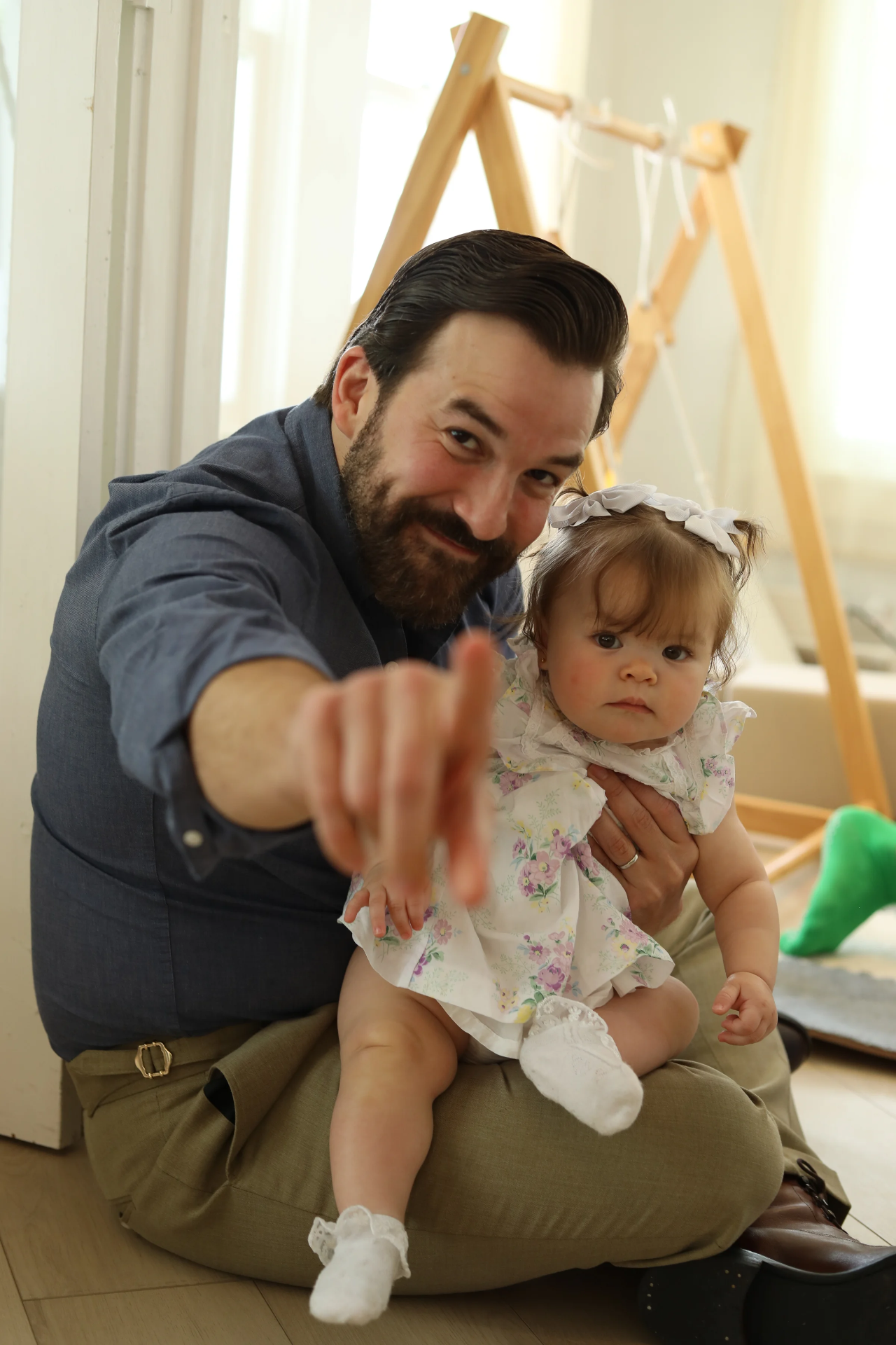 A father sitting with his baby at LOULOU HOUSE.